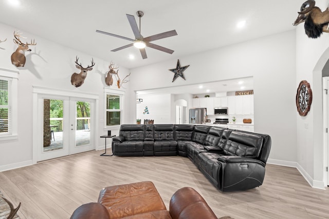 living room featuring french doors, light hardwood / wood-style floors, and ceiling fan