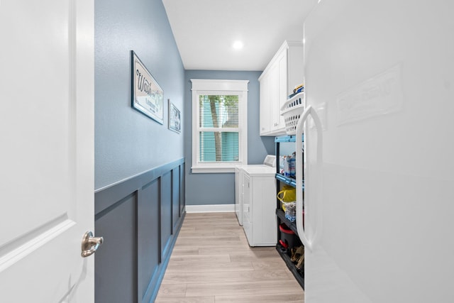 laundry area featuring light wood-type flooring and washing machine and clothes dryer