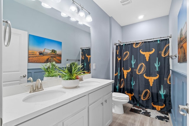 bathroom featuring vanity, toilet, a shower with shower curtain, and hardwood / wood-style flooring