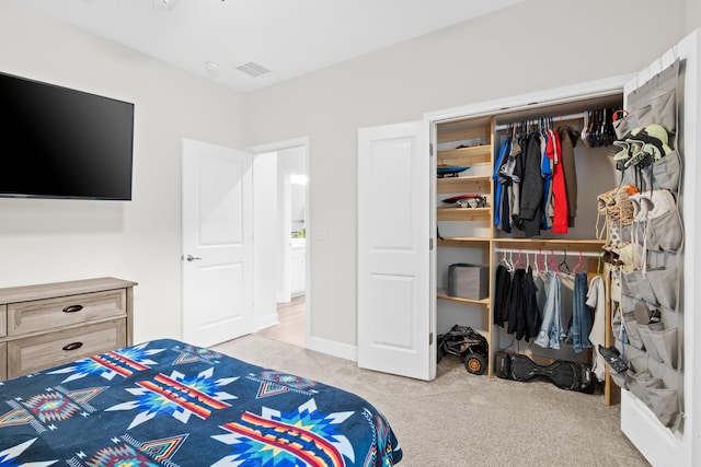 bedroom with light carpet and a closet