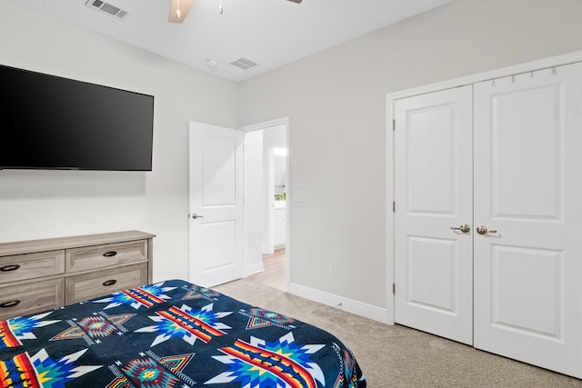 bedroom with light carpet, a closet, and ceiling fan