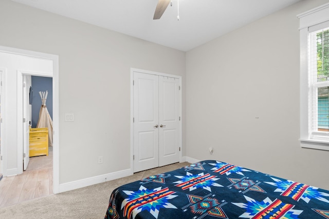 bedroom featuring hardwood / wood-style floors, ceiling fan, and a closet