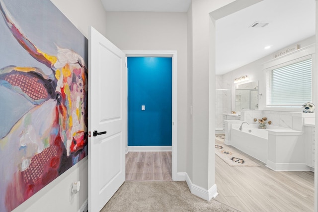 hallway with light hardwood / wood-style flooring