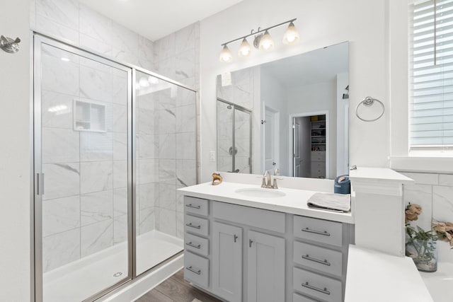 bathroom with vanity, hardwood / wood-style flooring, and walk in shower