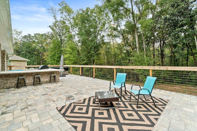 view of patio with area for grilling and exterior bar