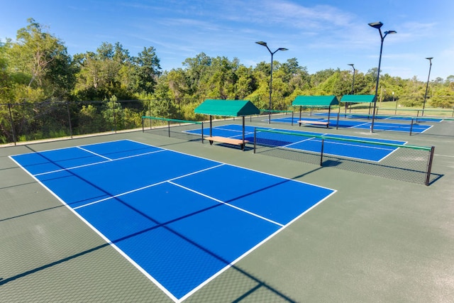 view of tennis court with basketball hoop