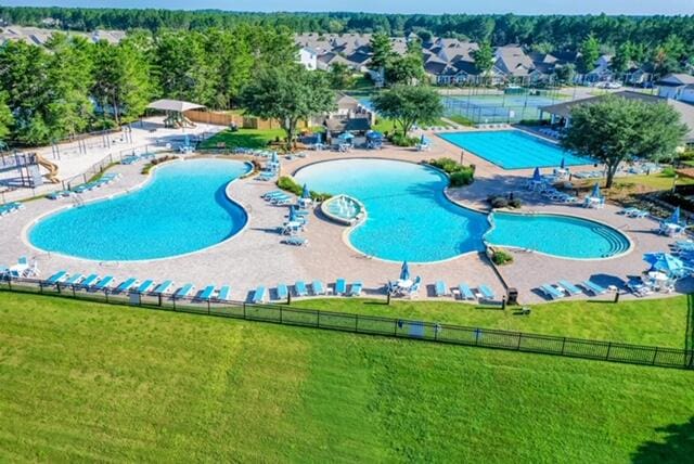 view of pool with a yard