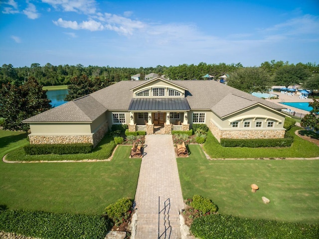 view of front of property with covered porch and a front yard