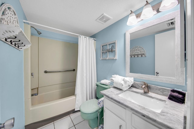 909 Santa Rosa Blvd Unit 561, Fort Walton Beach, FL 32548 - full bathroom with vanity, tile patterned floors, toilet, a textured ceiling, and shower / tub combo