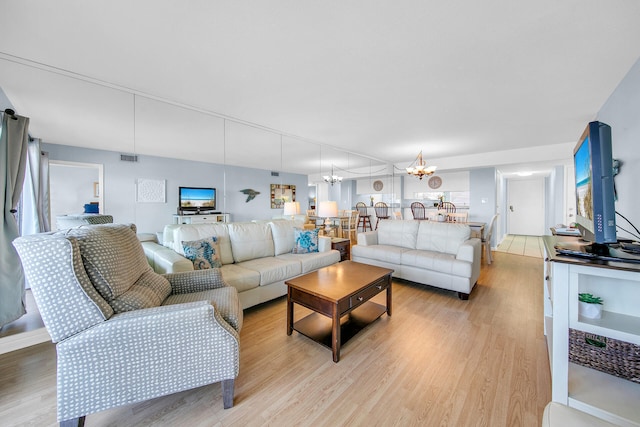 909 Santa Rosa Blvd Unit 561, Fort Walton Beach, FL 32548 - living room featuring a chandelier and light wood-type flooring