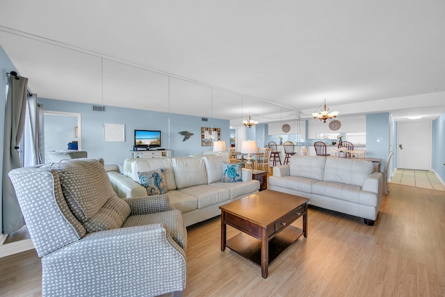 909 Santa Rosa Blvd Unit 561, Fort Walton Beach, FL 32548 - living room with a notable chandelier and light hardwood / wood-style floors