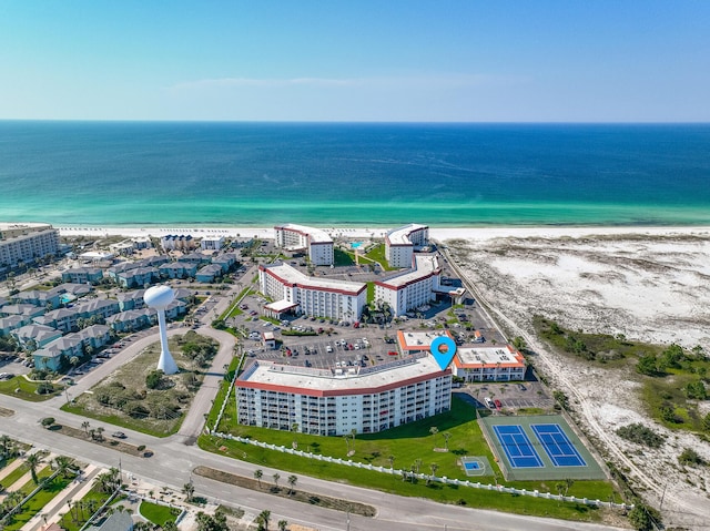 drone / aerial view with a water view and a beach view