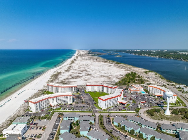 birds eye view of property with a beach view and a water view