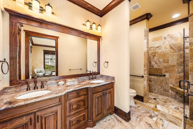 full bath with crown molding, a stall shower, and a sink