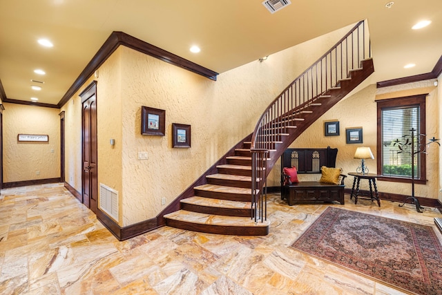 stairs featuring marble finish floor, recessed lighting, crown molding, baseboards, and a textured wall