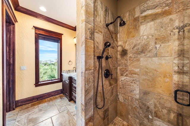 bathroom featuring vanity, crown molding, a stall shower, and stone tile flooring