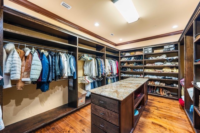 spacious closet featuring visible vents and light wood-type flooring