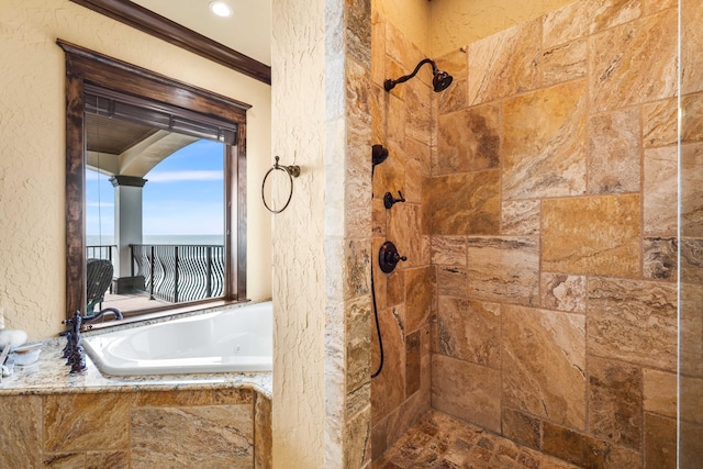 full bath featuring tiled shower, a bath, ornamental molding, and a textured wall