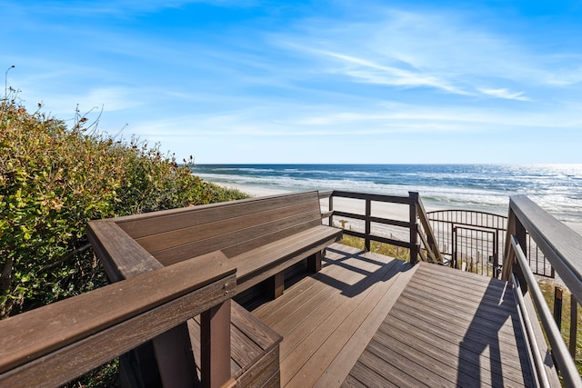 view of community with a water view and a beach view