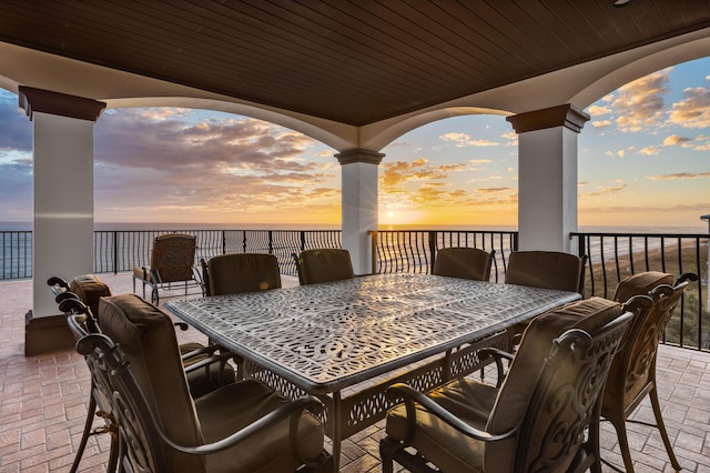 view of patio / terrace with outdoor dining space and a water view