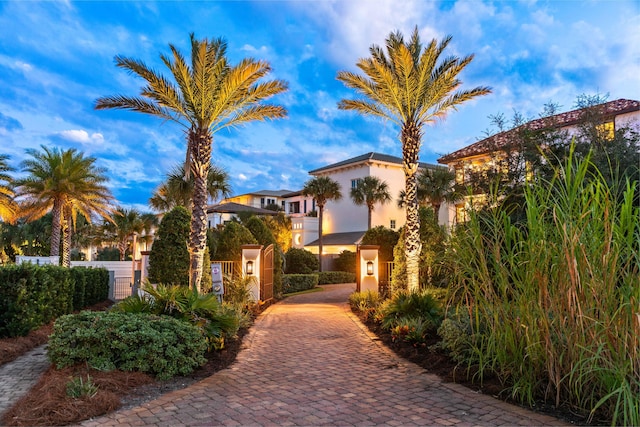 exterior space with a gate, a fenced front yard, and stucco siding