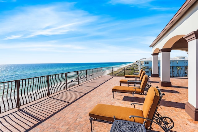 view of patio featuring a water view and a view of the beach