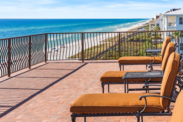 balcony featuring a beach view and a water view