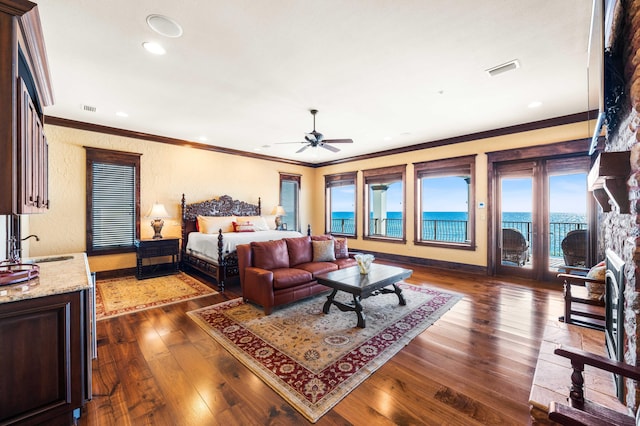 bedroom featuring access to exterior, visible vents, ornamental molding, and dark wood-style flooring