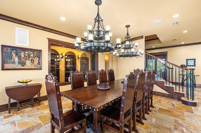 dining room with stone tile floors, crown molding, and an inviting chandelier