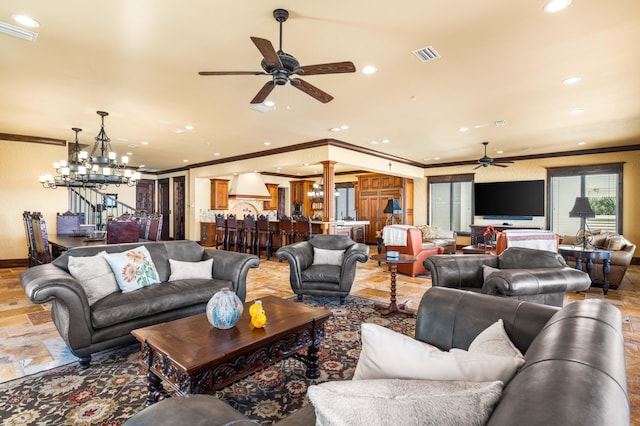 living area featuring ceiling fan with notable chandelier, visible vents, and ornamental molding