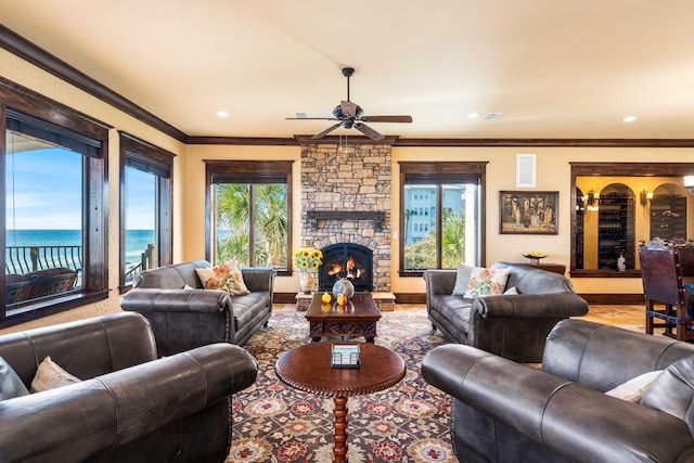 living room with a healthy amount of sunlight, ceiling fan, and ornamental molding