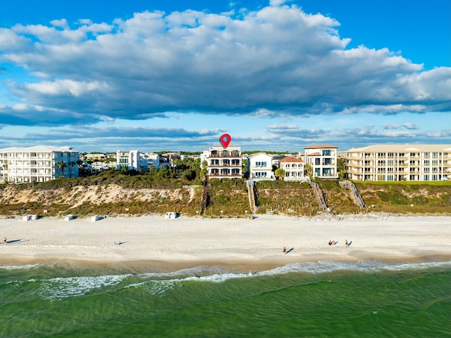 birds eye view of property with a view of the beach and a water view