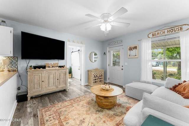 living room featuring a wealth of natural light, ceiling fan, and light wood-type flooring