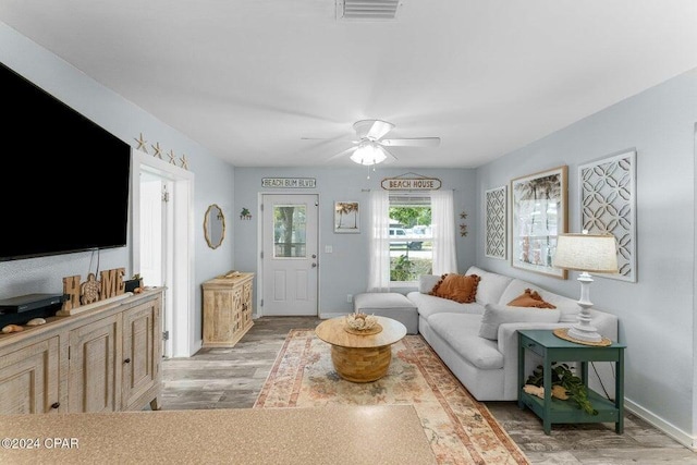 living room featuring hardwood / wood-style floors and ceiling fan