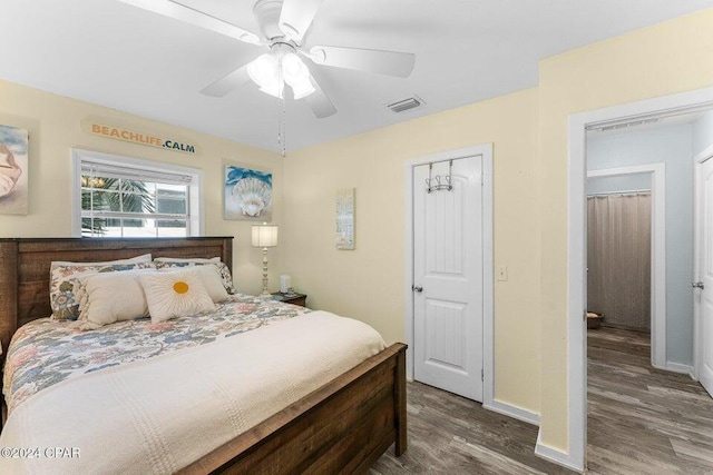 bedroom with ceiling fan, a closet, and dark hardwood / wood-style floors