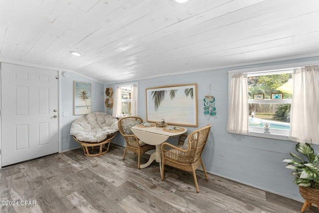 dining space featuring hardwood / wood-style flooring, lofted ceiling, and wood ceiling