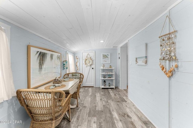 dining room with hardwood / wood-style floors and wooden ceiling