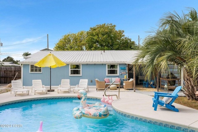 view of pool with an outdoor living space and a patio area