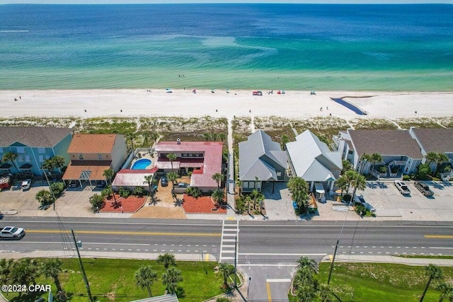 bird's eye view featuring a view of the beach and a water view