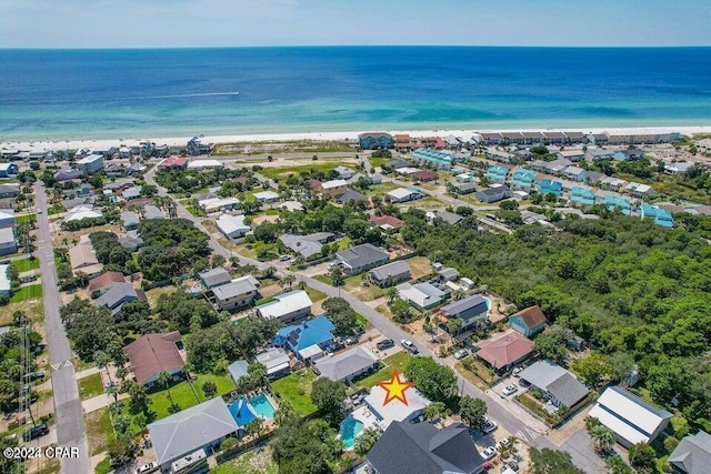 drone / aerial view featuring a beach view and a water view