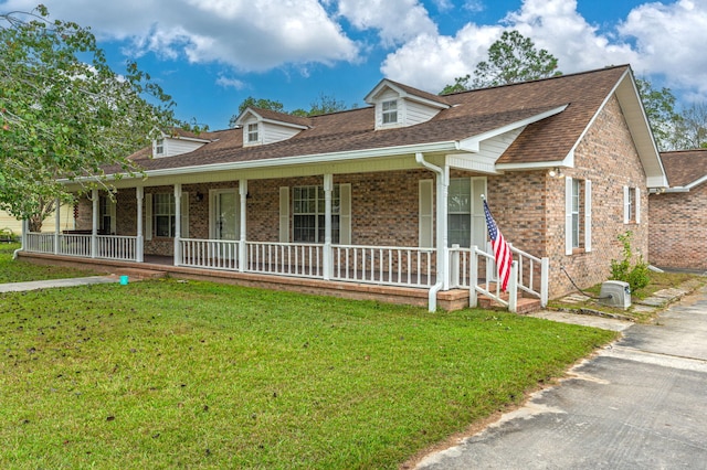 view of front of property with a porch and a front yard