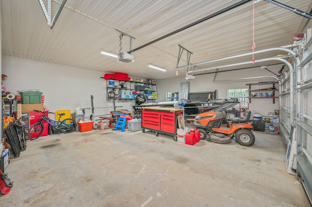 garage with a workshop area and a garage door opener