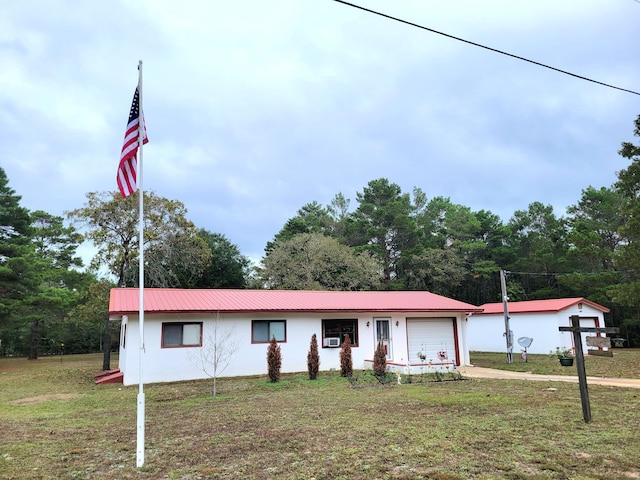 114 W May Lilly Ct, Defuniak Springs, FL 32433 - single story home featuring an attached garage, a front yard, stucco siding, and metal roof