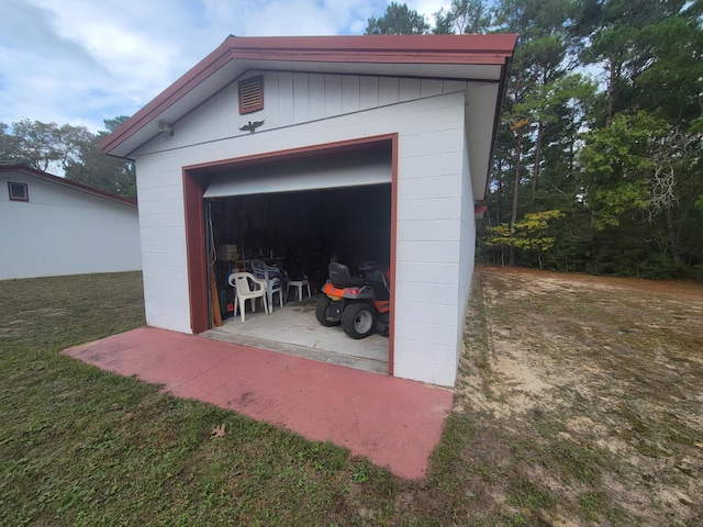 garage featuring a lawn