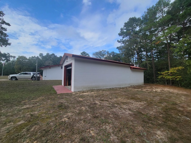 view of side of home with a yard