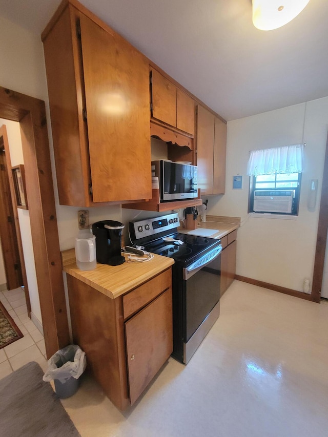 kitchen with stainless steel appliances and light tile patterned flooring