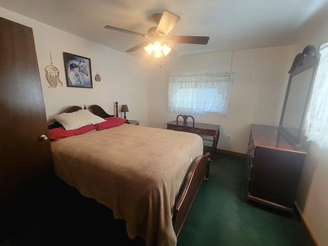 114 W May Lilly Ct, Defuniak Springs, FL 32433 - bedroom with dark colored carpet, ceiling fan, and baseboards