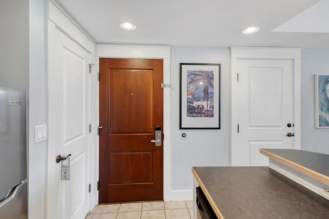 foyer entrance with light tile patterned floors