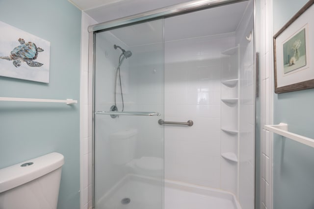 bathroom with toilet and walk in shower