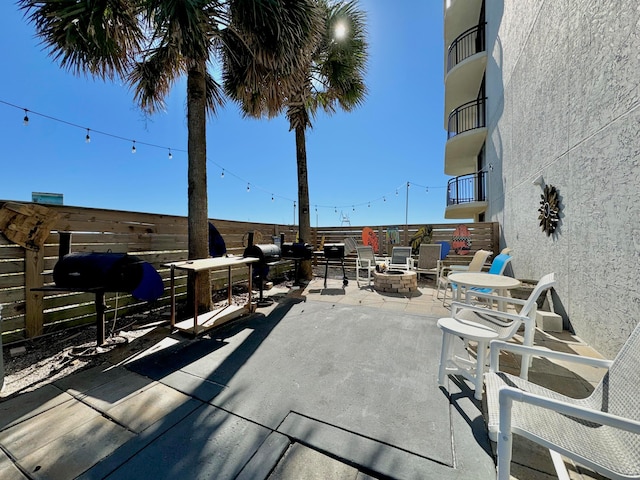 view of patio featuring area for grilling and a fire pit